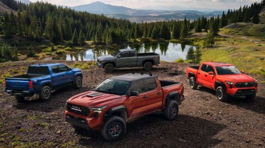 Four 2024 Toyota Tacoma trucks in blue, red, gray, and orange displayed in a natural landscape.