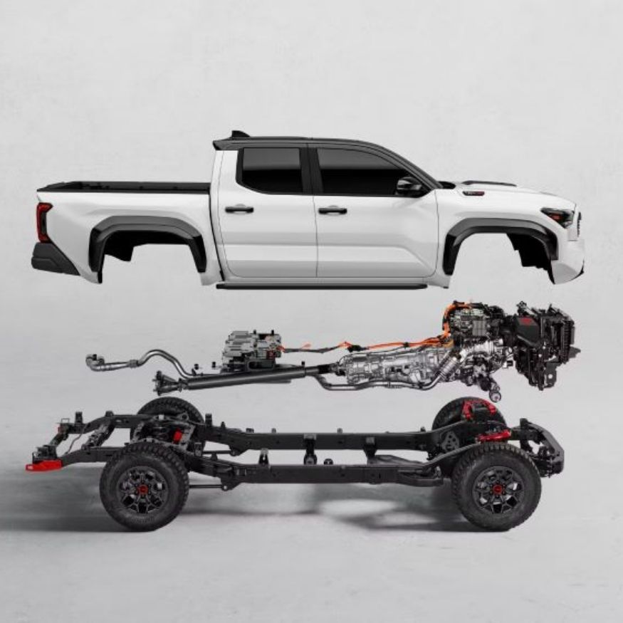 An exploded view of a white Toyota Tacoma showing the body, engine, and chassis components separated.